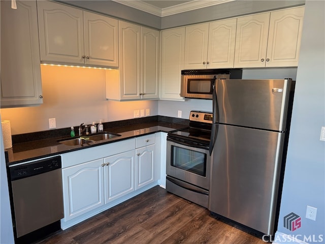 kitchen featuring sink, stainless steel appliances, dark hardwood / wood-style floors, white cabinets, and ornamental molding