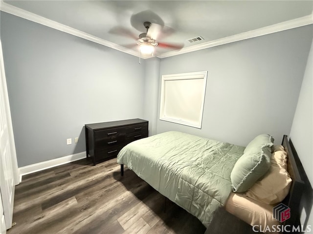 bedroom with ceiling fan, dark hardwood / wood-style floors, and crown molding