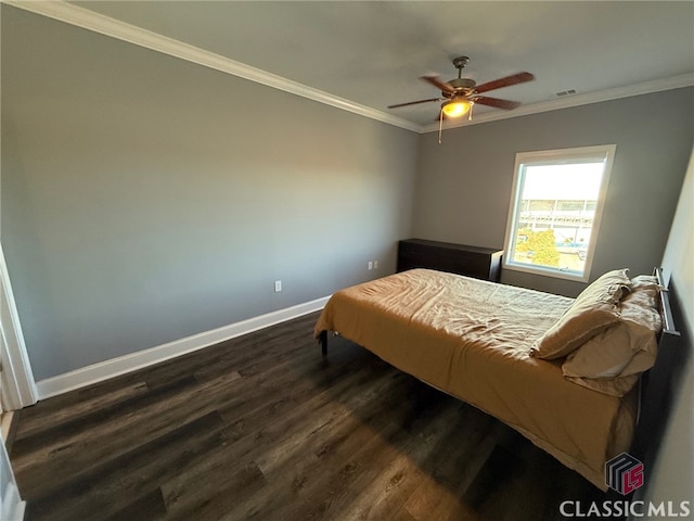 bedroom with ceiling fan, crown molding, and dark wood-type flooring