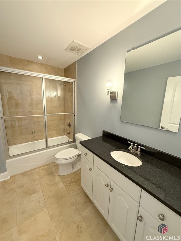 full bathroom featuring toilet, combined bath / shower with glass door, and vanity