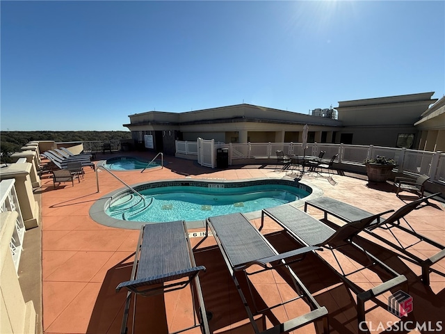 view of swimming pool featuring a patio area