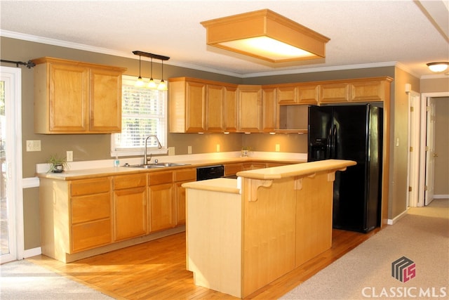 kitchen with light countertops, hanging light fixtures, a kitchen island, a sink, and black appliances