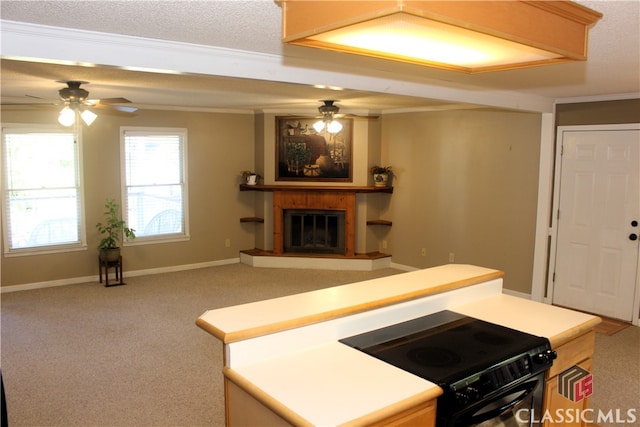 kitchen featuring open floor plan, light countertops, black / electric stove, and carpet