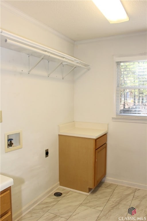 washroom featuring marble finish floor, hookup for a washing machine, ornamental molding, electric dryer hookup, and a textured ceiling