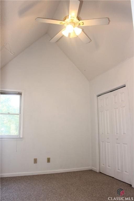 unfurnished bedroom with lofted ceiling, carpet, baseboards, and a ceiling fan