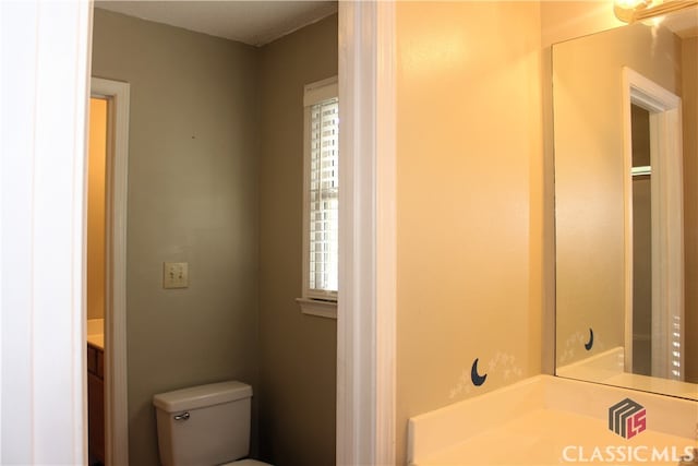 bathroom with toilet and vanity