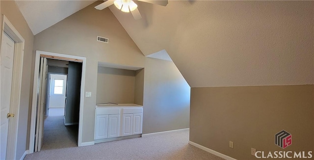 bonus room with light colored carpet, visible vents, ceiling fan, and lofted ceiling