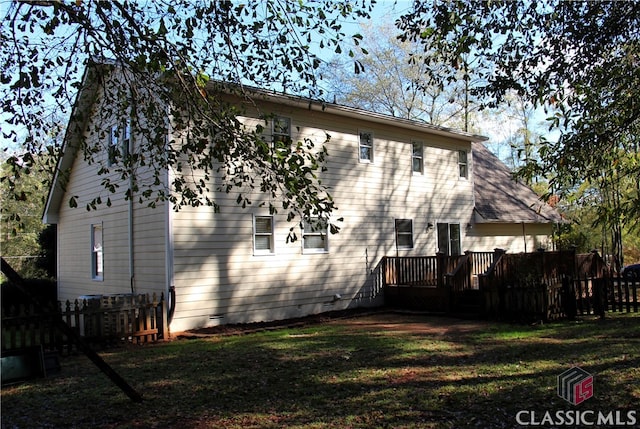 back of house with a yard, crawl space, and a wooden deck