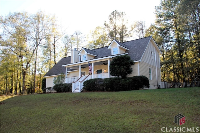 view of front of home with ceiling fan, stairs, a front lawn, and a porch