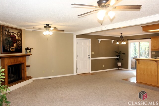 unfurnished living room with light carpet, a textured ceiling, and a glass covered fireplace