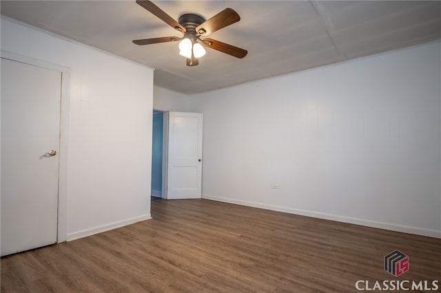 unfurnished bedroom featuring ceiling fan and dark hardwood / wood-style floors