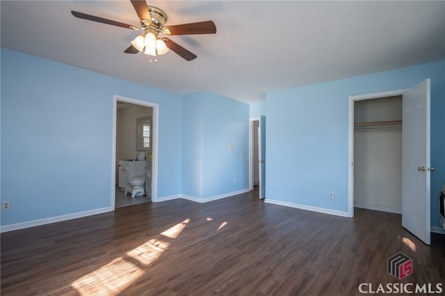 unfurnished bedroom featuring a closet, ensuite bath, ceiling fan, and dark hardwood / wood-style flooring