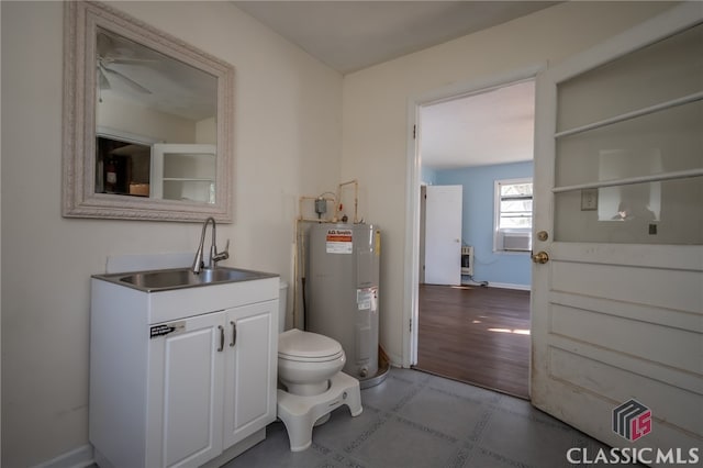 bathroom with sink, ceiling fan, toilet, water heater, and wood-type flooring