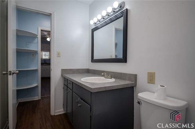 bathroom featuring hardwood / wood-style floors, vanity, and toilet