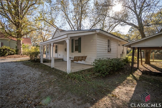 view of side of property featuring a porch