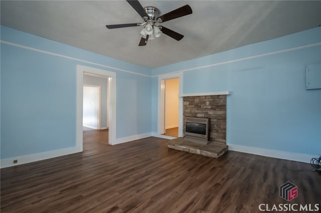 unfurnished living room featuring a fireplace, ceiling fan, and dark hardwood / wood-style flooring