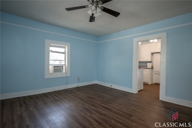 spare room featuring ceiling fan, cooling unit, and dark hardwood / wood-style flooring