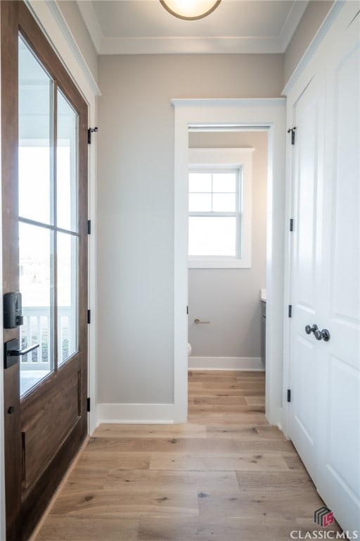 kitchen featuring a wealth of natural light, high end fridge, white cabinets, and decorative light fixtures