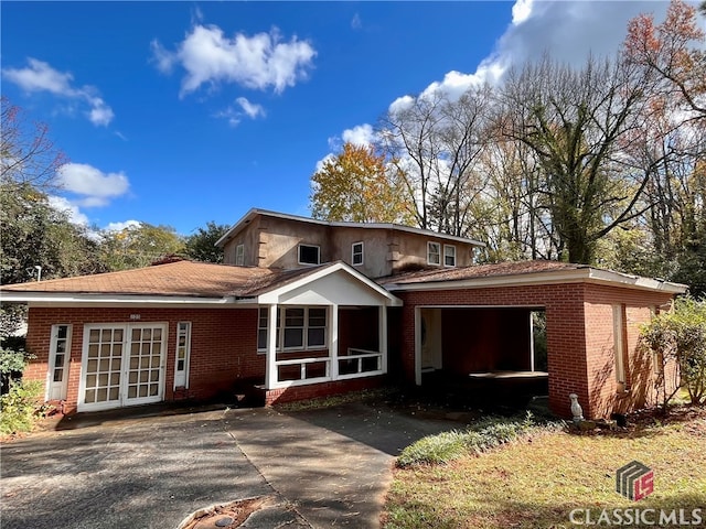 view of front of property with a carport and french doors