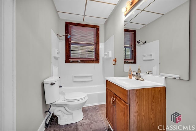 full bathroom featuring tile patterned floors, toilet, shower / tub combination, a paneled ceiling, and vanity