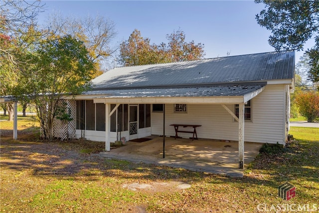 back of property featuring a sunroom