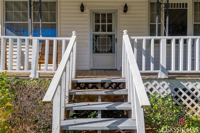 doorway to property featuring covered porch