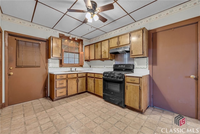 kitchen with gas stove, ceiling fan, and sink