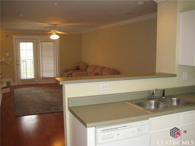 kitchen featuring white dishwasher, crown molding, sink, wood-type flooring, and white cabinetry