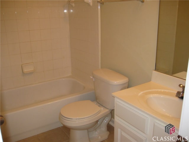 full bathroom featuring toilet, vanity, tile patterned floors, and tiled shower / bath