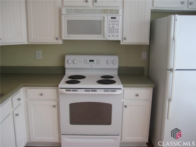 kitchen with white appliances and white cabinetry