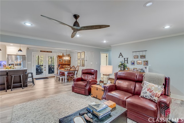 living room with ceiling fan, french doors, light hardwood / wood-style floors, and ornamental molding