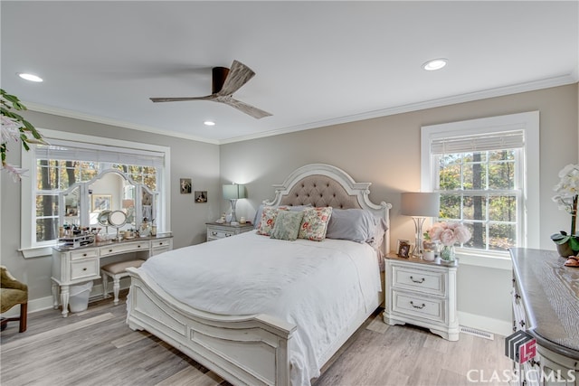 bedroom featuring ceiling fan, crown molding, and light hardwood / wood-style flooring