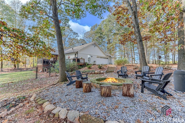 view of yard with a fire pit and a garage