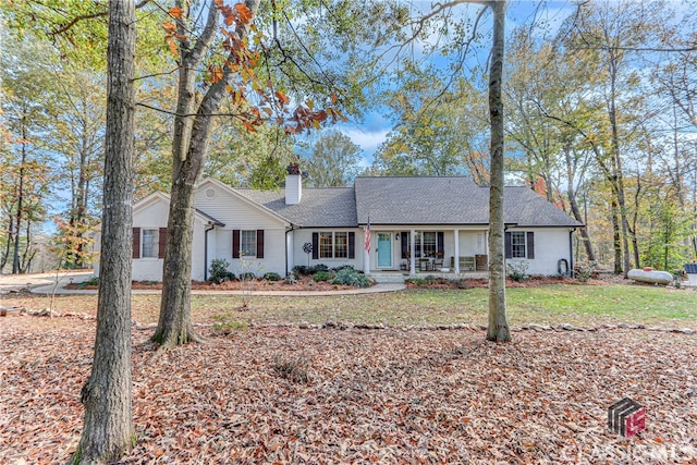 single story home with a porch and a front lawn