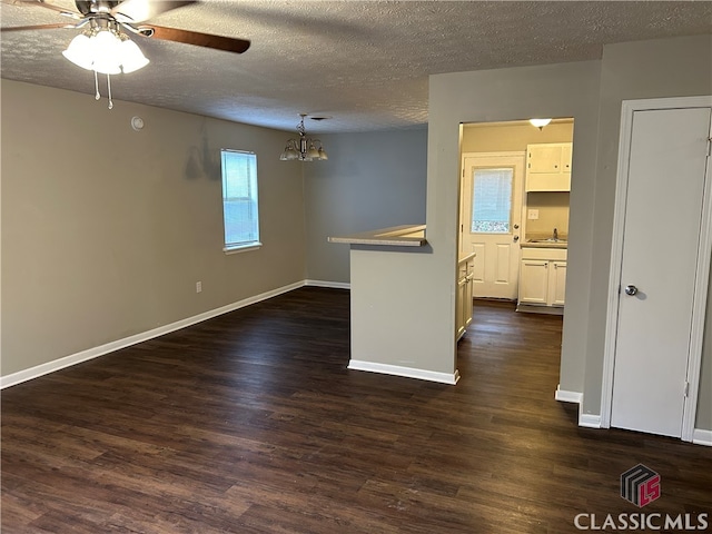 unfurnished room with dark hardwood / wood-style flooring, a textured ceiling, and sink