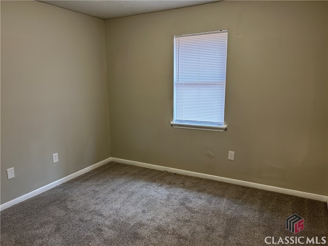 carpeted spare room with a textured ceiling