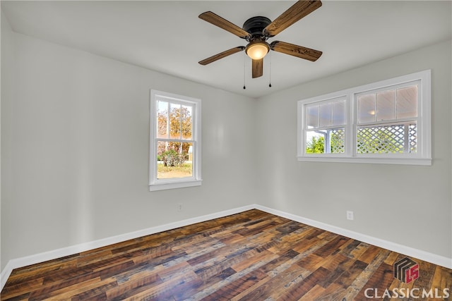 empty room with dark hardwood / wood-style floors and ceiling fan