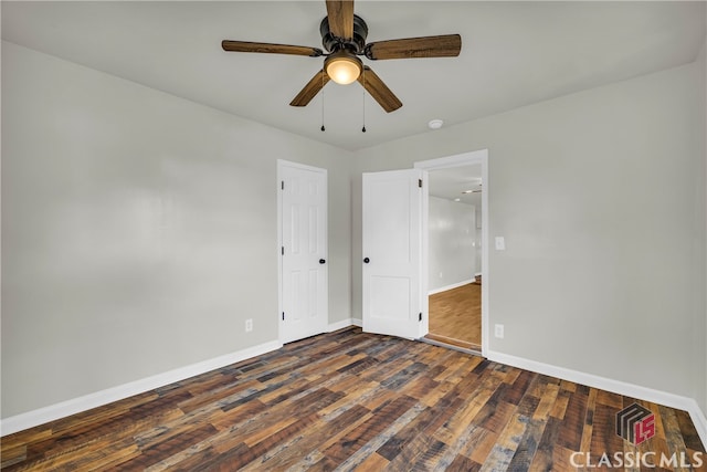 unfurnished bedroom featuring ceiling fan and dark hardwood / wood-style flooring