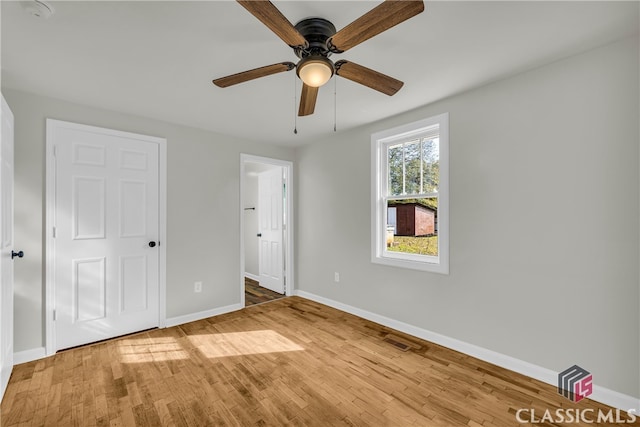 unfurnished bedroom with ceiling fan and light wood-type flooring