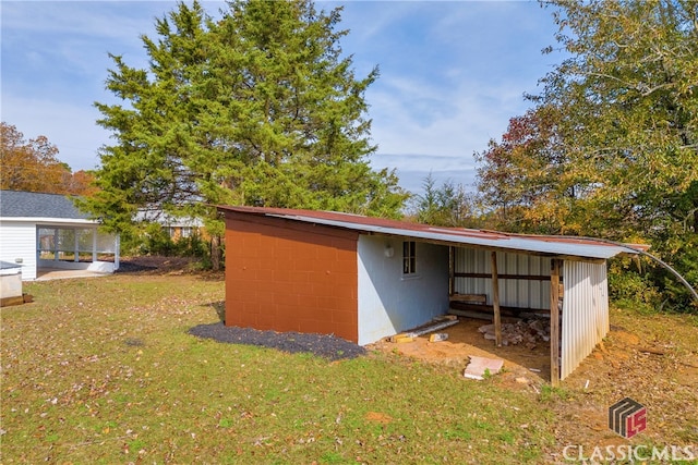 view of outbuilding with a yard