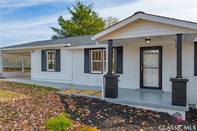 view of exterior entry with covered porch