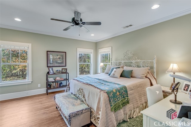 bedroom with ceiling fan, crown molding, and light wood-type flooring