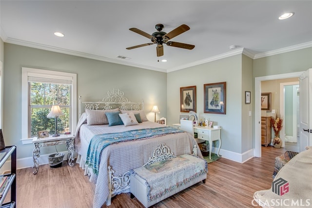 bedroom featuring ceiling fan, crown molding, and hardwood / wood-style flooring