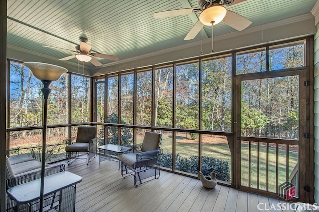 unfurnished sunroom with ceiling fan