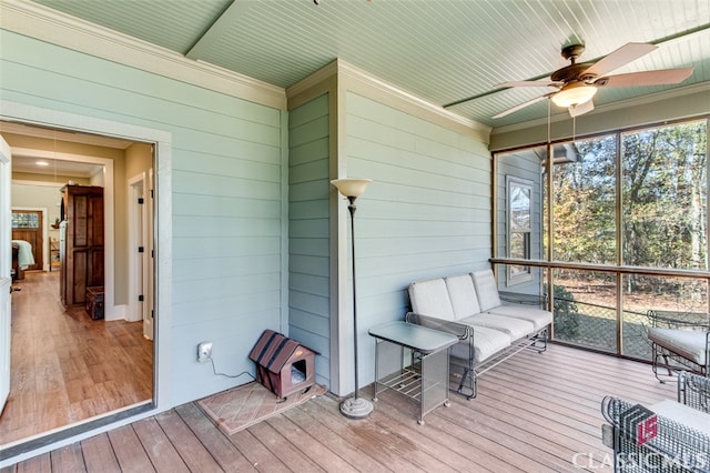 sunroom featuring ceiling fan