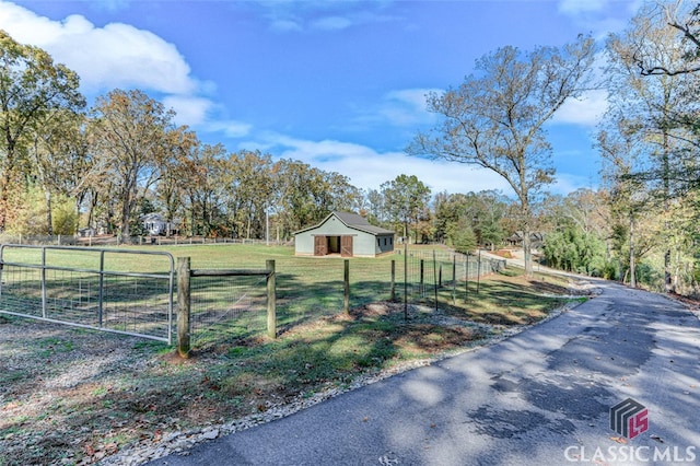 exterior space featuring a rural view and a front lawn