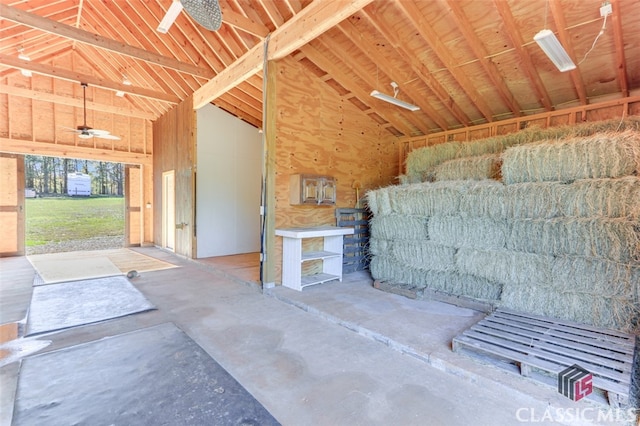 miscellaneous room with high vaulted ceiling and concrete floors