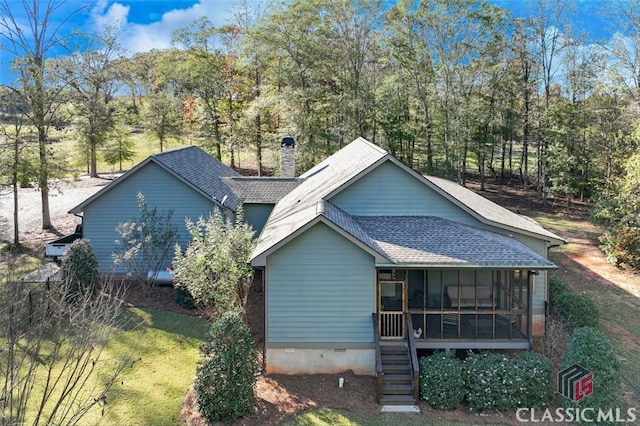 rear view of house featuring a sunroom