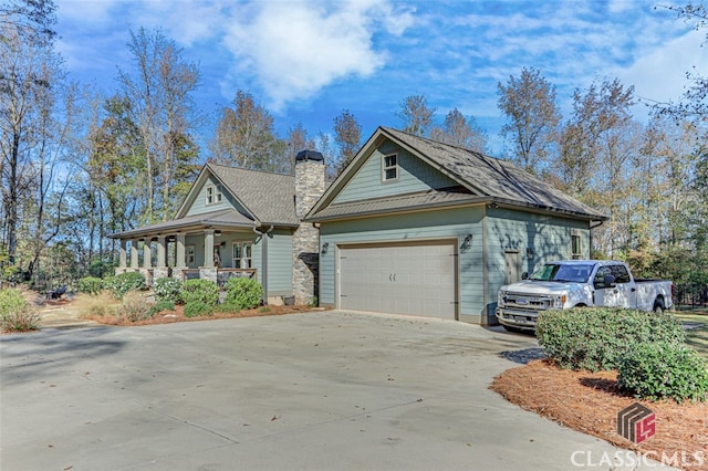 view of front of property with a porch and a garage