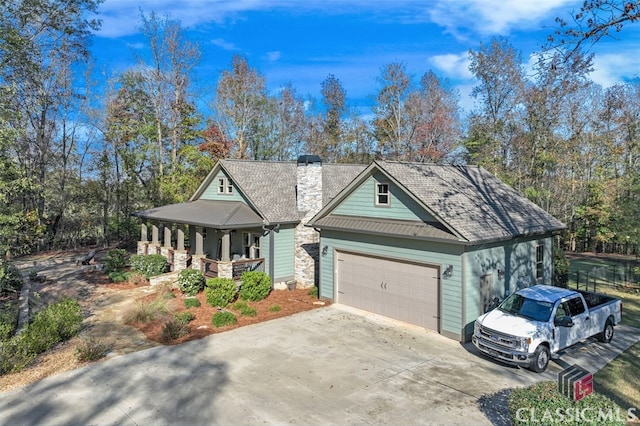 view of front of property featuring covered porch and a garage